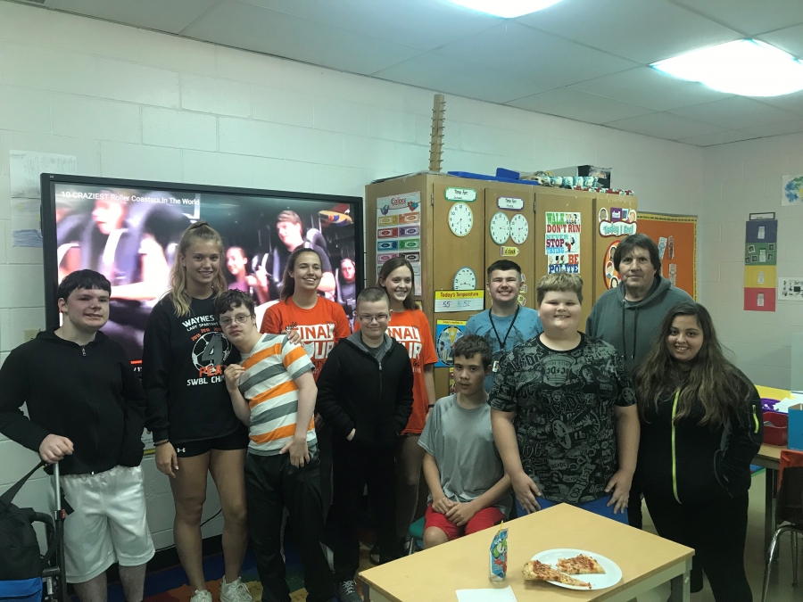 group of students with pizza on the table